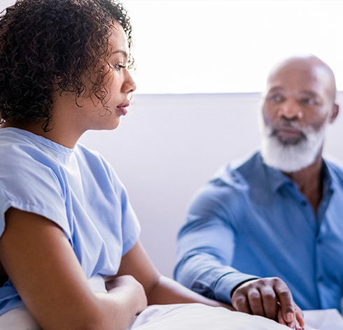 Healthcare professional discussing TNBC treatment options with a patient in a clinical setting